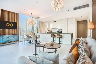 a living room with a couch and a table at Waterfront 2BR District One Residence - Near Downtown and Lagoon in Dubai
