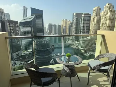 a balcony with a table and chairs and a view of a city at LMY Wharf 2 Marina View Suites - Dubai JBR Marina in Dubai