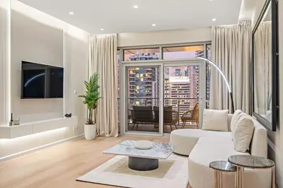 a living room with a white couch and a table at FIRST CLASS 1BR Panoramic Marina Views in Dubai