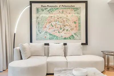a living room with a white couch and a map at FIRST CLASS 1BR Panoramic Marina Views in Dubai
