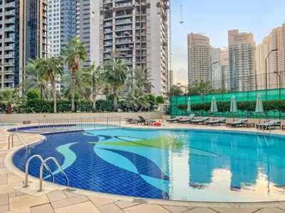 a swimming pool in a city with tall buildings at FIRST CLASS 1BR Panoramic Marina Views in Dubai