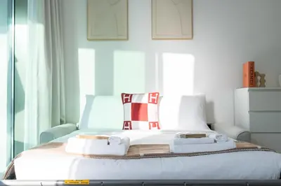 a bedroom with a bed with towels on it at Skyview Experience View Burj Khalifa Pool, Canal in Dubai