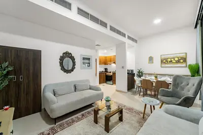 a living room with a couch and a table at FIRST CLASS Villa Peaceful Pool View Retreat in Dubai
