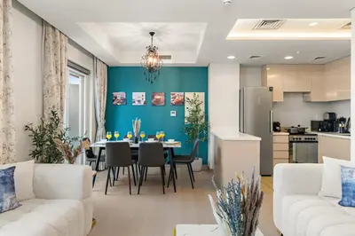 a living room with a table and a kitchen at FIRST CLASS VILLA Zen Luxe Contemporary Haven in Dubai