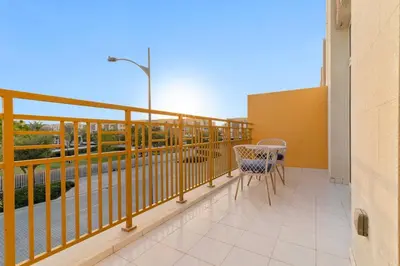 a balcony with a table and chairs on it at FIRST CLASS VILLA Zen Luxe Contemporary Haven in Dubai
