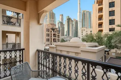 a balcony with chairs and a view of a city at FIRST CLASS 2BR Old Town Burj View Retreat in Dubai