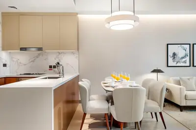 a kitchen and dining room with a table and chairs at FIRST CLASS 2BR Burj Khalifa & Fountain View in Dubai