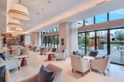 a restaurant with chairs and tables and windows at FIRST CLASS 2BR Burj Khalifa & Fountain View in Dubai