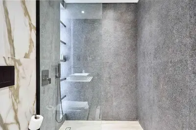 a bathroom with a shower with a glass door at Modern Studio at Oxford Gardens Arjan - Near Miracle Garden in Dubai