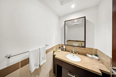a bathroom with a sink and a mirror at FIRST CLASS 1BR Sophisticated Downtown Escape in Dubai