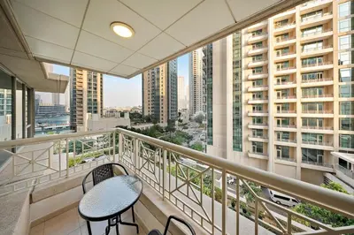 a balcony with a table and chairs in a building at FIRST CLASS 1BR Sophisticated Downtown Escape in Dubai