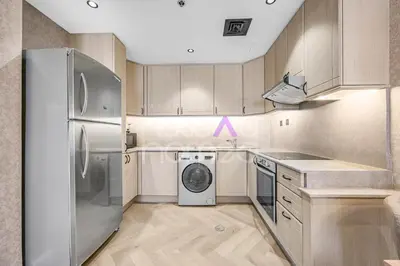 a kitchen with a refrigerator and a washing machine at Amazing 2BR Princess Tower Dubai Marina in Dubai
