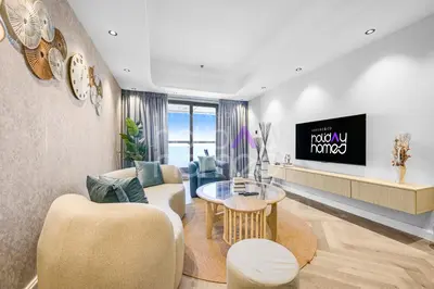 a living room with a couch and a table at Amazing 2BR Princess Tower Dubai Marina in Dubai