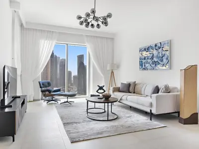 a living room with a couch and a table at Elegant 2BDR Full BurjKhalifa View In Downtown-06 in Dubai