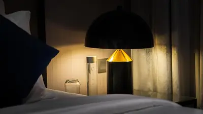 a lamp sitting on a table next to a bed at Downtown Dubai Mall Walkable 8 min in Dubai