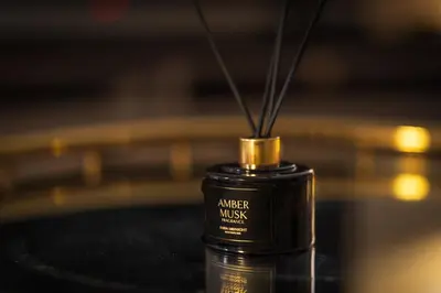 a black bottle with a gold top sitting on a table at Downtown Dubai Mall Walkable 8 min in Dubai