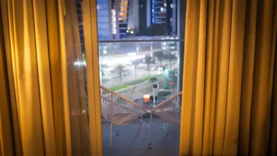 a window with a table and chairs on a balcony at Downtown Dubai Mall Walkable 8 min in Dubai