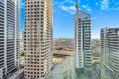 a view of two tall buildings in a city at Peaceful, Unique 1BR Experience ,Dubai Marina in Dubai
