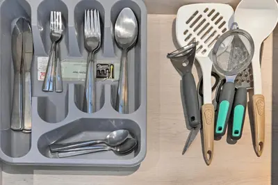 a lunch box with utensils on a table at Peaceful, Unique 1BR Experience ,Dubai Marina in Dubai