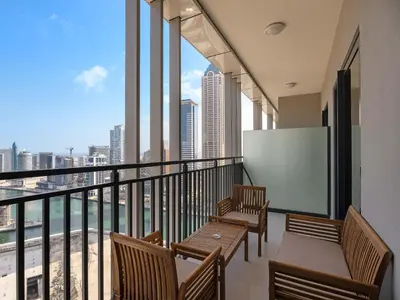 a balcony with chairs and tables and a view of the city at Premium 1 BDR in Zada Tower-Business Bay in Dubai