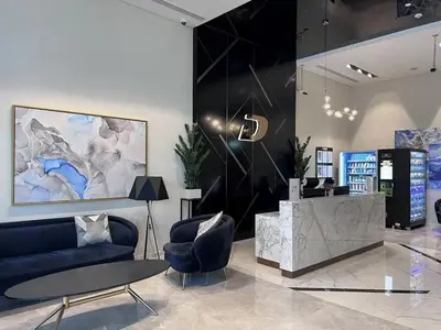a lobby with a couch and chairs and a table at Premium 1 BDR in Zada Tower-Business Bay in Dubai
