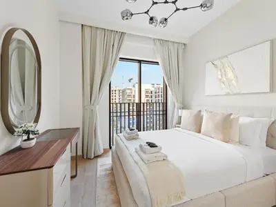 a white bedroom with a large bed and a window at Luxury Elegance 2BDR In Sunset-Creek Beach-03 in Dubai