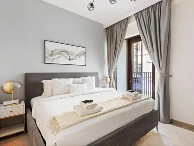 a bedroom with a large bed with two towels on it at Luxury Elegance 2BDR In Sunset-Creek Beach-03 in Dubai
