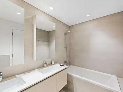 a bathroom with a tub and a sink and a mirror at Luxury Elegance 2BDR In Sunset-Creek Beach-03 in Dubai