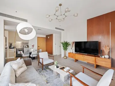 a living room with a couch and a flat screen tv at Luxury Elegance 2BDR In Sunset-Creek Beach-03 in Dubai