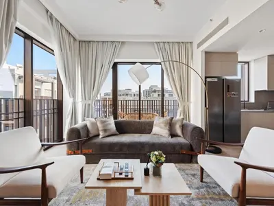 a living room with a couch and a table at Luxury Elegance 2BDR In Sunset-Creek Beach-03 in Dubai
