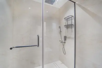 a shower with a glass door in a bathroom at Zaafaran 1- Luxury 2BR Apt Near Burj Khalifa & Dubai Mall in Dubai