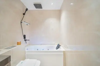 a bathroom with a bath tub and a toilet at Zaafaran 1- Luxury 2BR Apt Near Burj Khalifa & Dubai Mall in Dubai