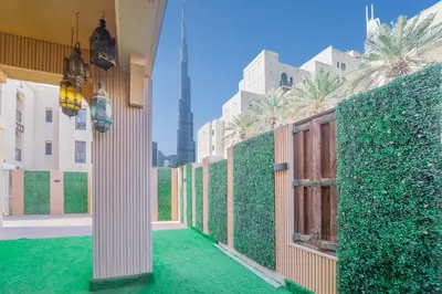 a room with a green hedge and a wooden door at Zaafaran 1- Luxury 2BR Apt Near Burj Khalifa & Dubai Mall in Dubai