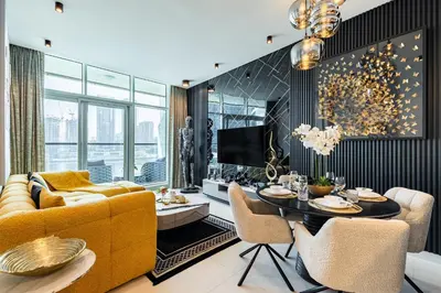 a living room with a yellow couch and a table at Ultra-Luxe Breathtaking Canal Views l Business Bay in Dubai