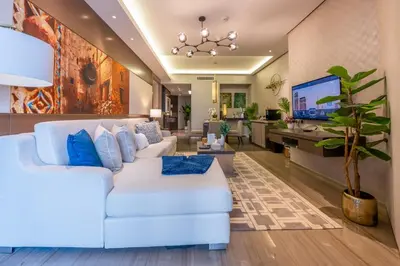 a living room with a white couch and a tv at City View Lux 1 BR in Creek Heights Upgraded by UDH in Dubai