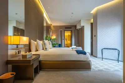 a large bedroom with a large bed and a desk at City View Lux 1 BR in Creek Heights Upgraded by UDH in Dubai