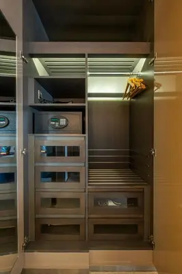 a walk in closet with wooden doors and drawers at City View Lux 1 BR in Creek Heights Upgraded by UDH in Dubai