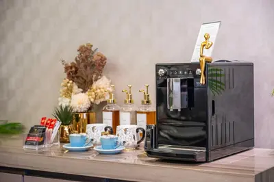 a microwave sitting on a counter with cups and mugs at City View Lux 1 BR in Creek Heights Upgraded by UDH in Dubai