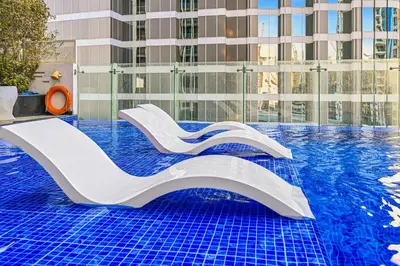 a swimming pool with a slide in a building at Bayz by Denube in Dubai