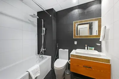 a bathroom with a white toilet and a sink at Bayz by Denube in Dubai