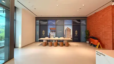 a room with two tables and a brick wall at Hadley Heights! Pool & Gym Access! 2 Double Bed, Balcony with a Great View! in Dubai