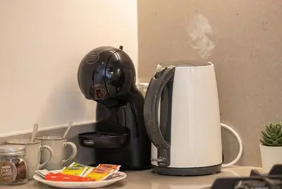 a coffee maker on a counter next to a paper towel at Hadley Heights! Pool & Gym Access! 2 Double Bed, Balcony with a Great View! in Dubai