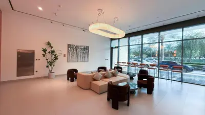 a living room with a couch and chairs and windows at Hadley Heights! Pool & Gym Access! 2 Double Bed, Balcony with a Great View! in Dubai