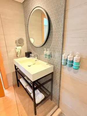 a bathroom with a sink and a mirror at Novotel JVT Studio 5 Star Amenities Access in Dubai