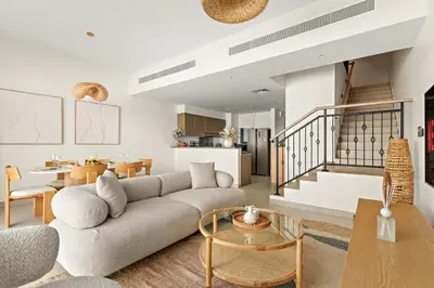 a living room with a couch and a table at VayK - Modern 4 BD Townhouse with Private Garden in Damac Lagoons in Dubai