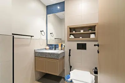 a bathroom with a sink and a shower and a toilet at VayK - Modern 4 BD Townhouse with Private Garden in Damac Lagoons in Dubai