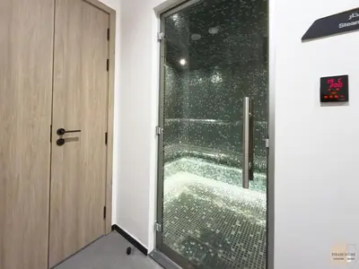 a glass door in a room with a window at Réveille Face au Burj Khalifa Vu Canal & Piscine in Dubai