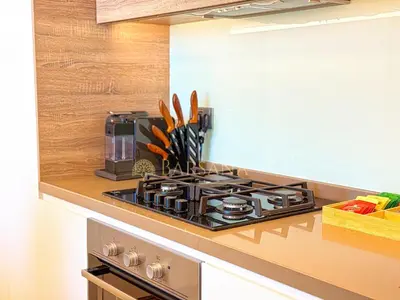 a kitchen with a stove and a counter top at Barsana - Seabreeze Suite - 2 Bed - Sea Views in Dubai
