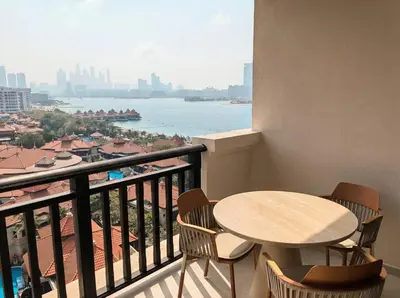 a balcony with a table and chairs and a view of the water at Palm Horizon | Luxury Anantara Studio in Dubai