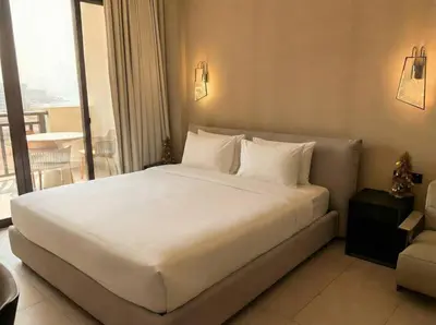 a large white bed in a hotel room at Palm Horizon | Luxury Anantara Studio in Dubai